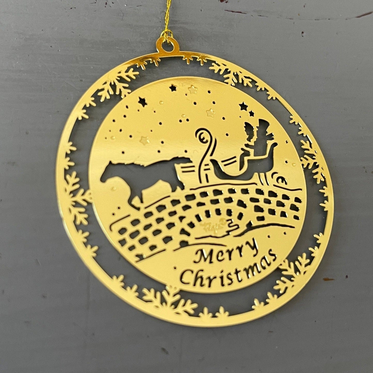 Horse drawn sleigh on an old stone bridge Merry Christmas 2 inch round gold-tone metal ornament