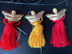 A trio of terrific tassel angels with porcelain heads gold family wings and floss bodies