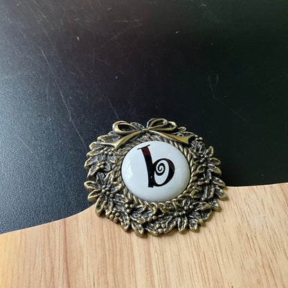 Cute cutting board with beautiful brass wreath medallion embellished with a b cross stitch finishing button wall hanging